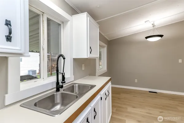 a kitchen with stainless steel appliances granite countertop a sink and a stove