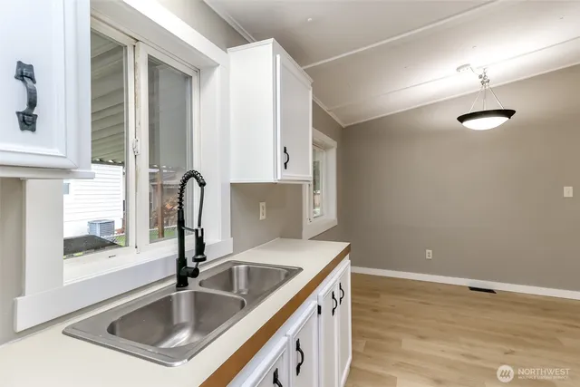 a kitchen with stainless steel appliances granite countertop a sink and a stove