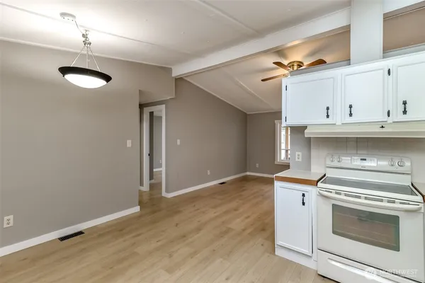 a kitchen with granite countertop a refrigerator a sink and a dishwasher