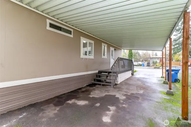 a backyard of a house with childrens swings and slides