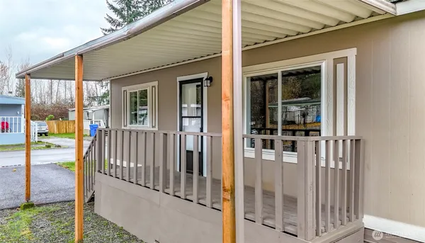 a house view with swimming pool and trees in the background