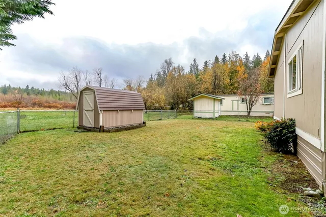 an aerial view of a house with swimming pool garden and trees
