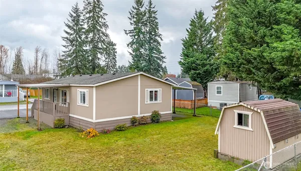 an aerial view of a house with swimming pool garden and patio