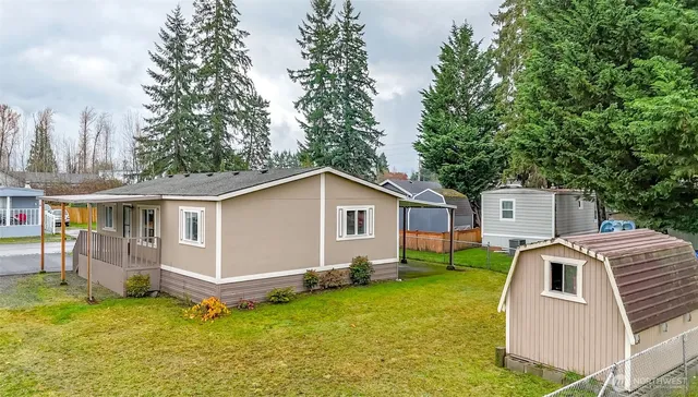 an aerial view of a house with swimming pool garden and patio