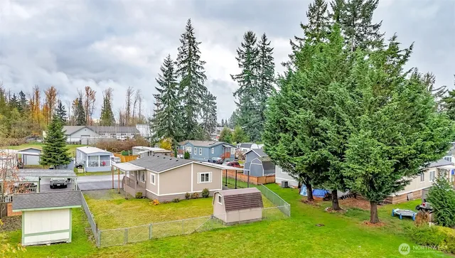 an aerial view of a house with a yard