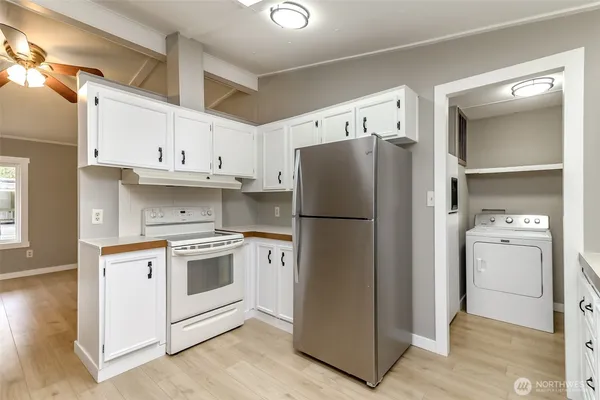 a kitchen with a refrigerator sink and cabinets