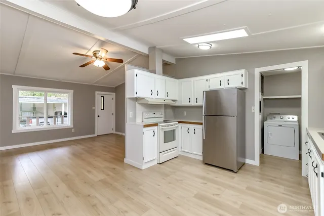 a kitchen with a refrigerator and a stove top oven