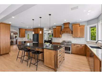 a kitchen with stainless steel appliances kitchen island granite countertop a sink and cabinets