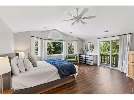 a bedroom with furniture and a large window