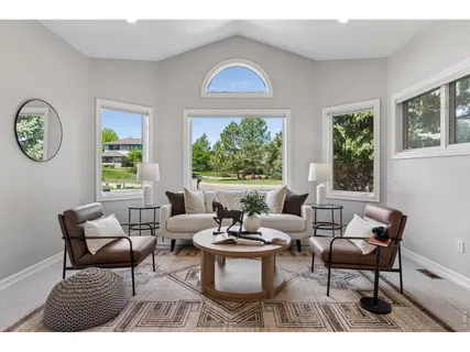 a living room with furniture a window and a large window