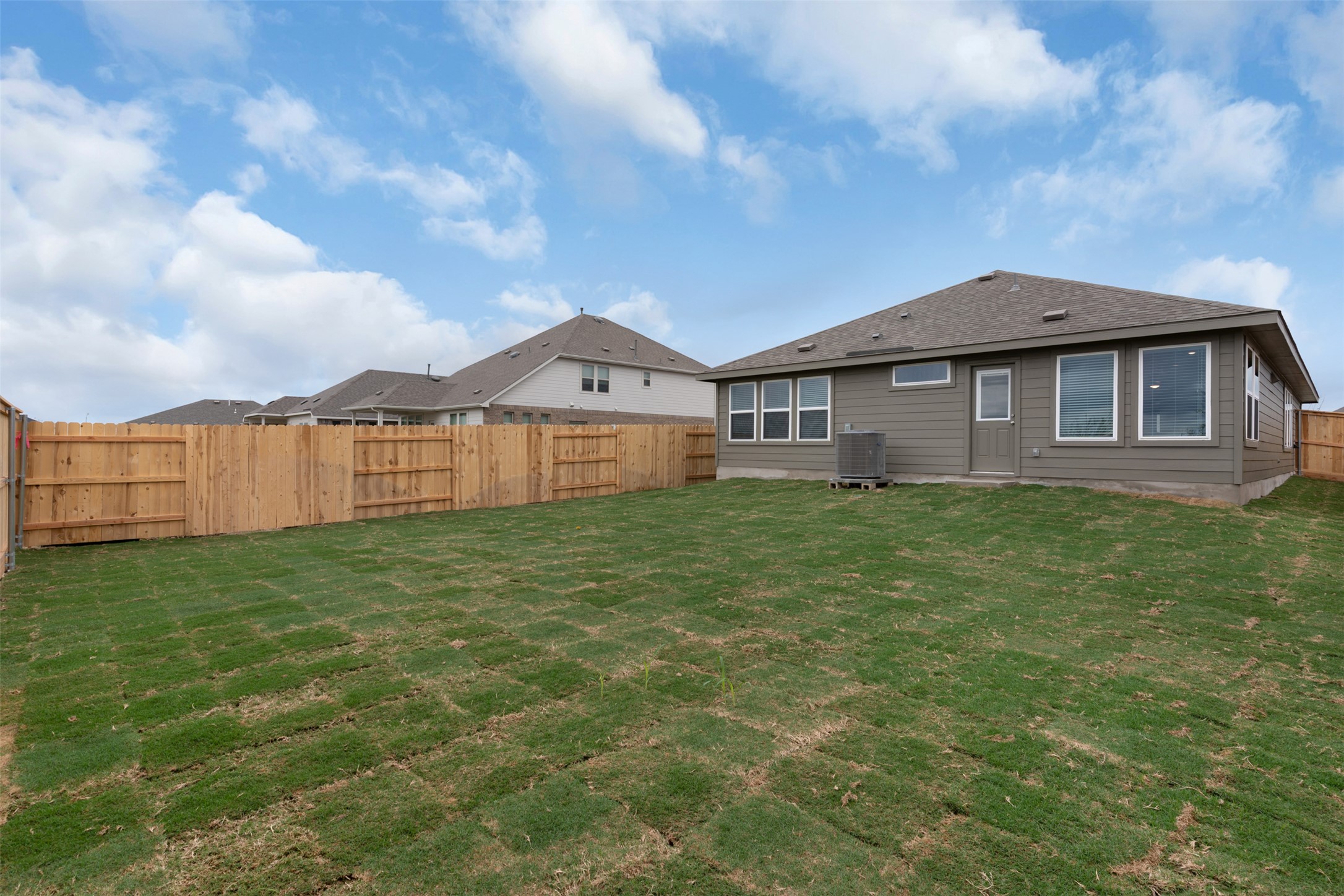 13721 Tucker Hedge Pass Elgin, TX 78621 - Photo 20 of 28 Rear view of property featuring a fenced backyard and a shingled roof