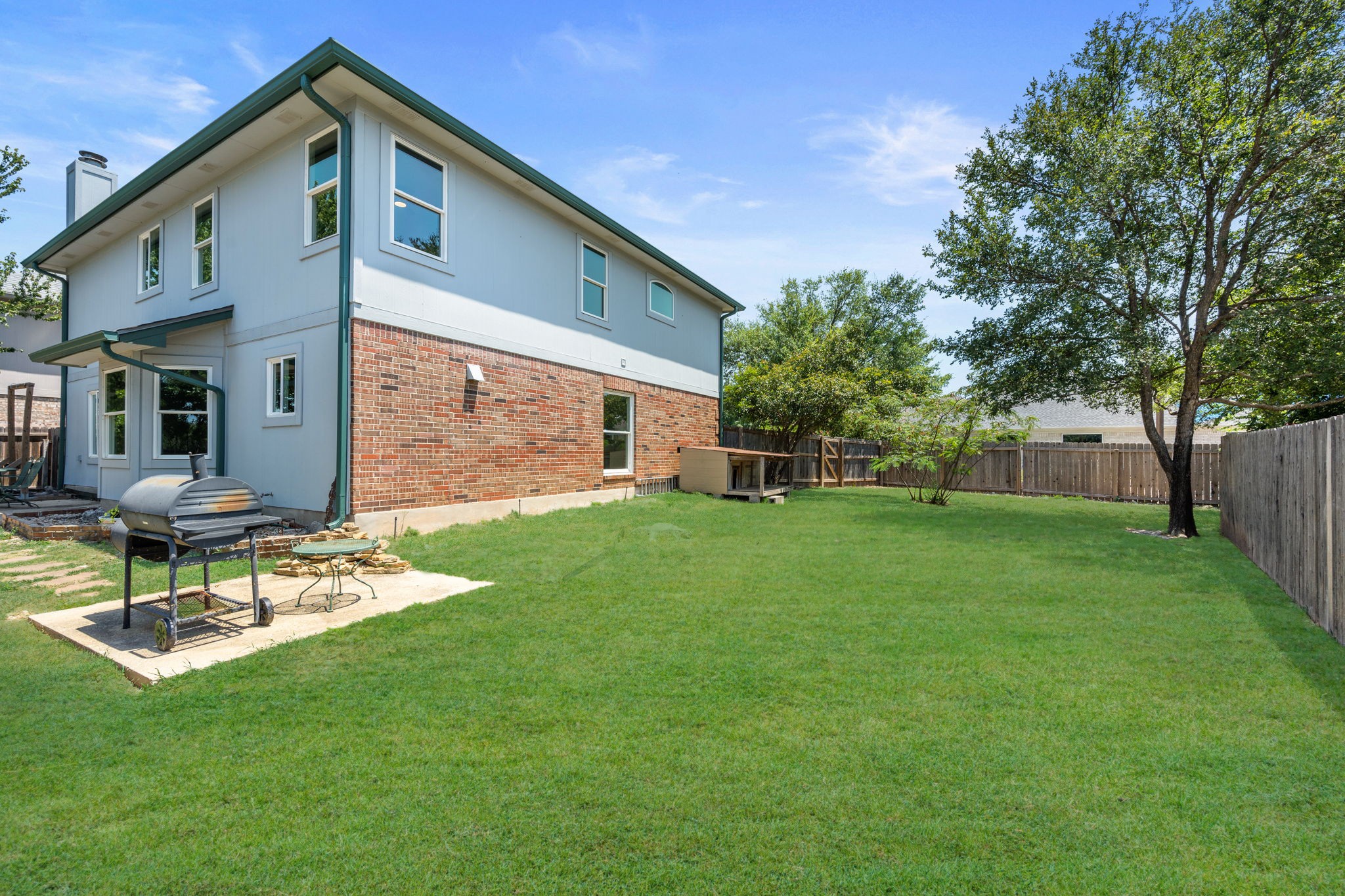 2440 Madeline Loop Cedar Park, TX 78613 - Photo 31 of 33 Rear view of house featuring a fenced backyard, a chimney, brick siding, and a patio