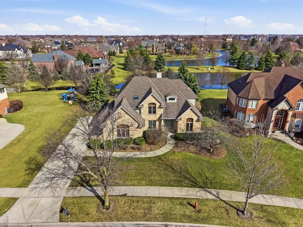 an aerial view of a house with a big yard