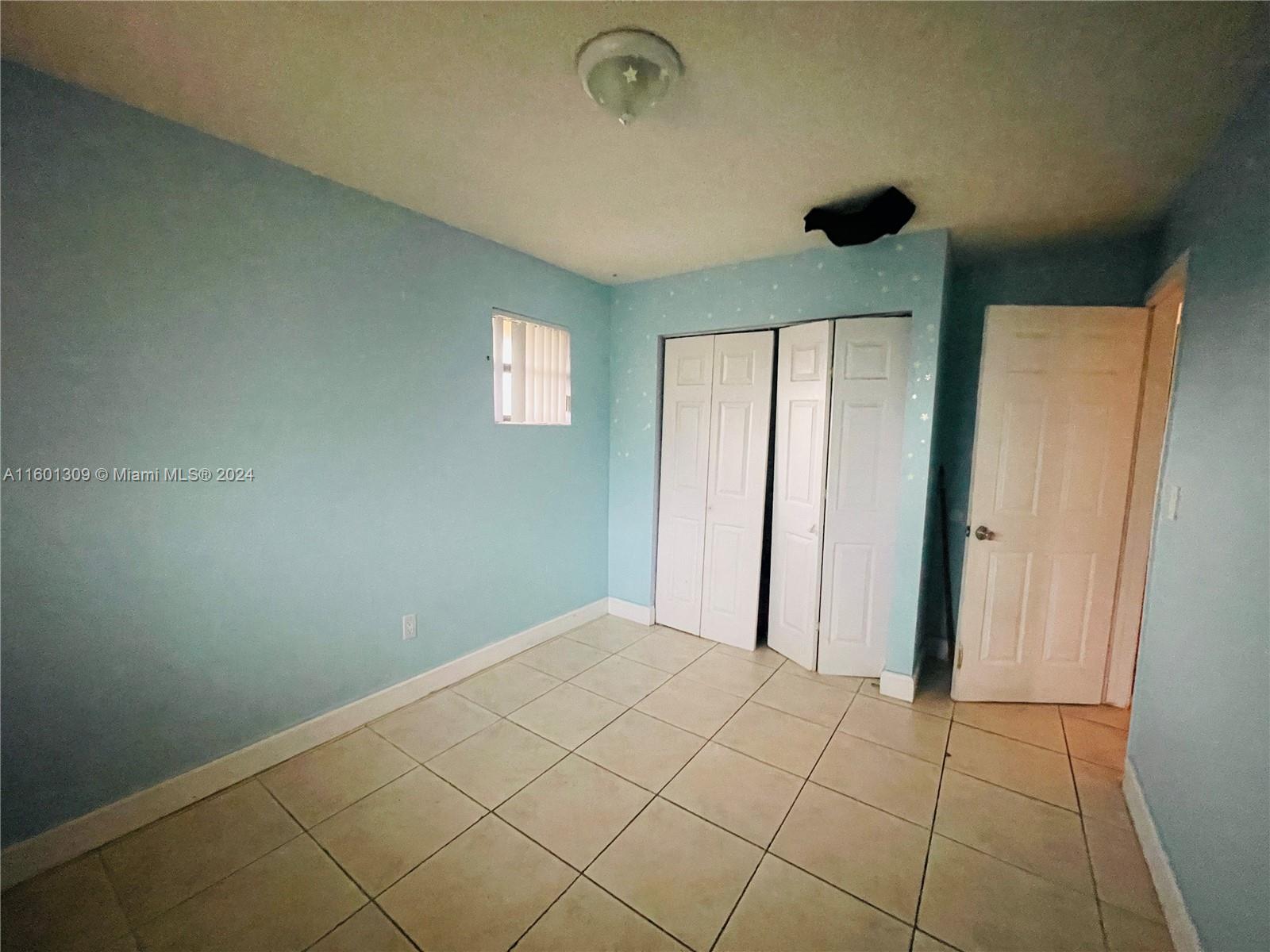6475 Southwest 129th Place, Unit 4034 Miami, FL 33183 - Photo 11 of 15 an empty room with a empty space and windows