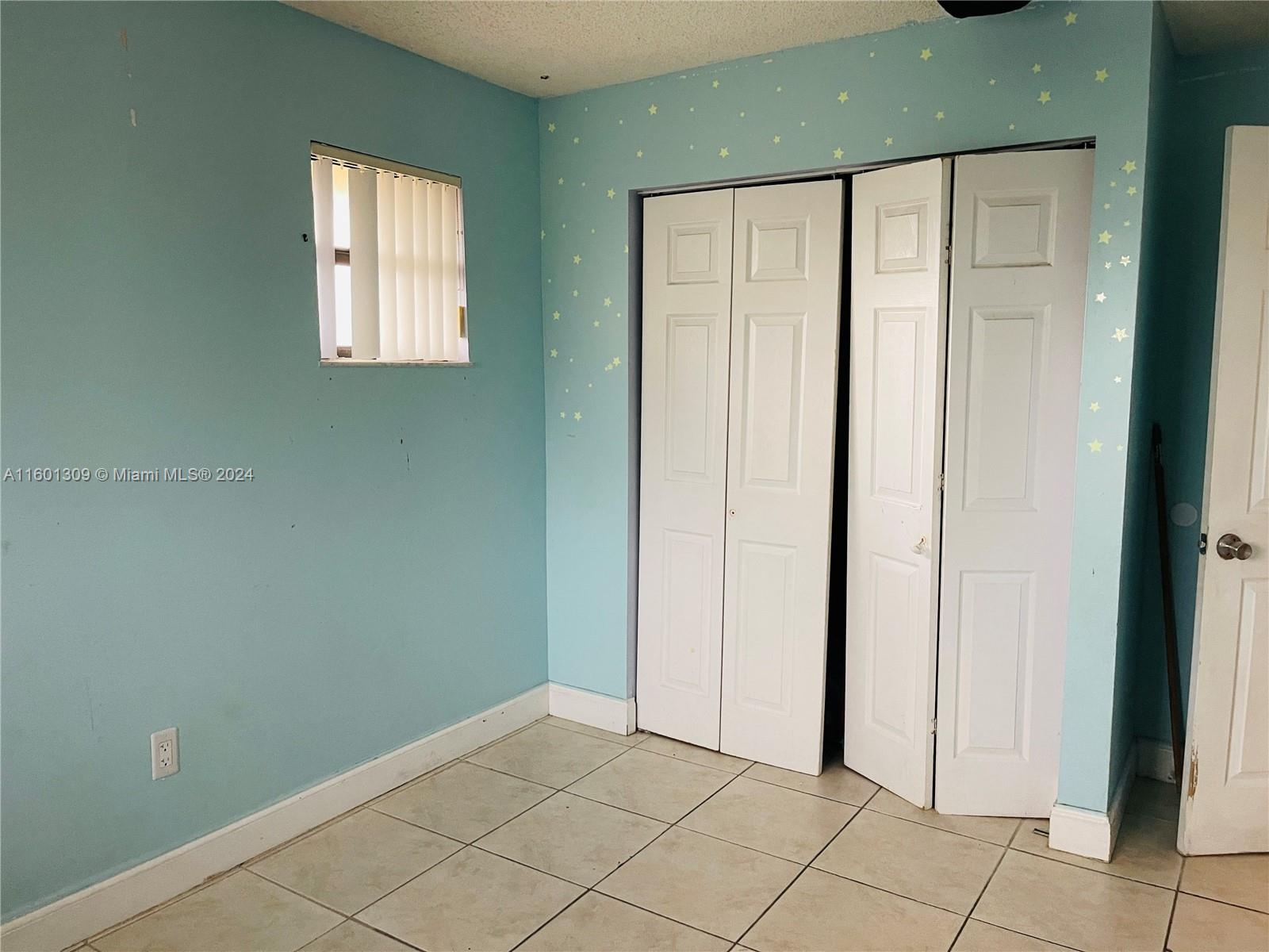 6475 Southwest 129th Place, Unit 4034 Miami, FL 33183 - Photo 12 of 15 a view of an empty room with window and bathroom