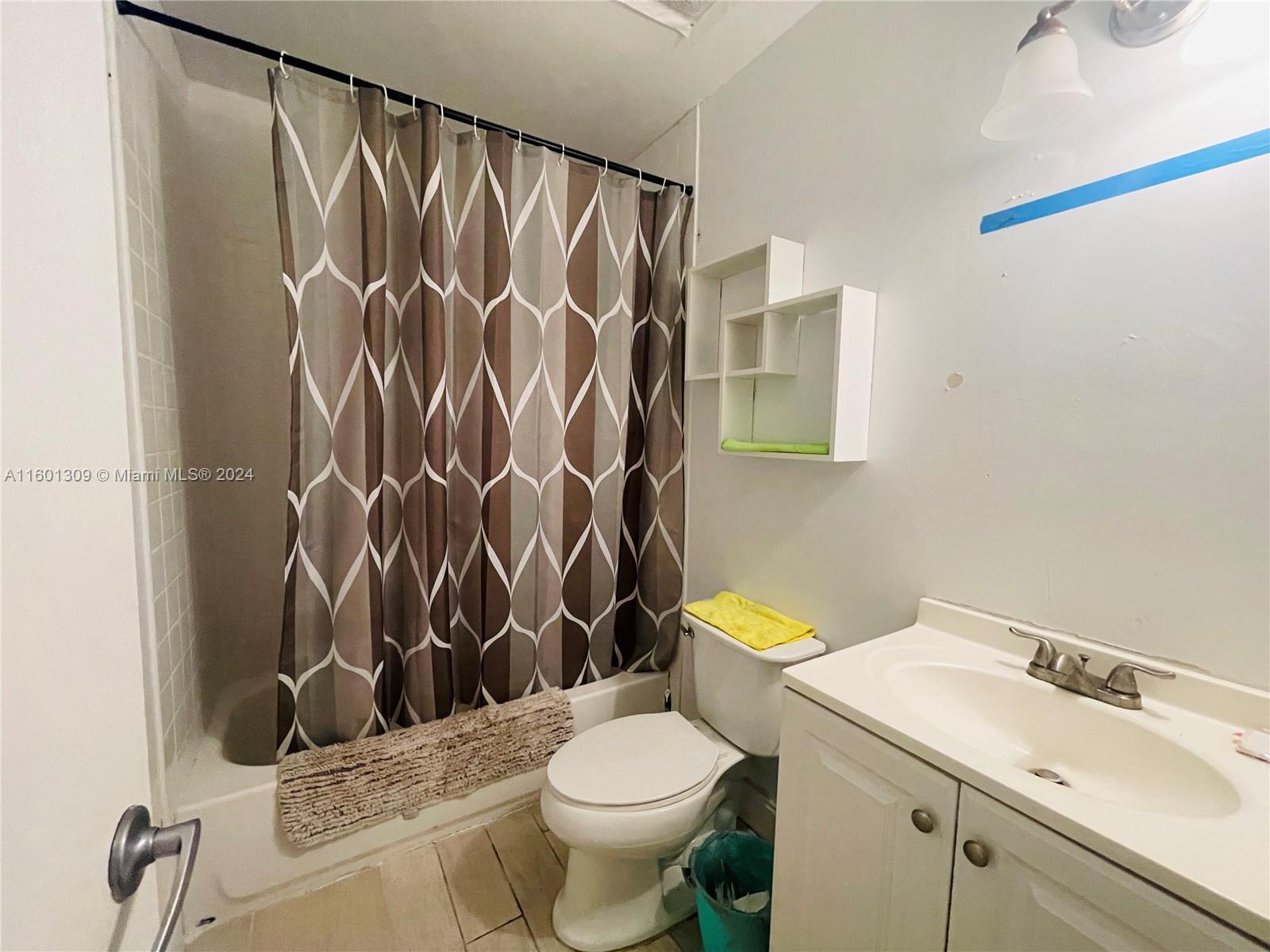 6475 Southwest 129th Place, Unit 4034 Miami, FL 33183 - Photo 13 of 15 a white toilet sitting next to a bathroom sink