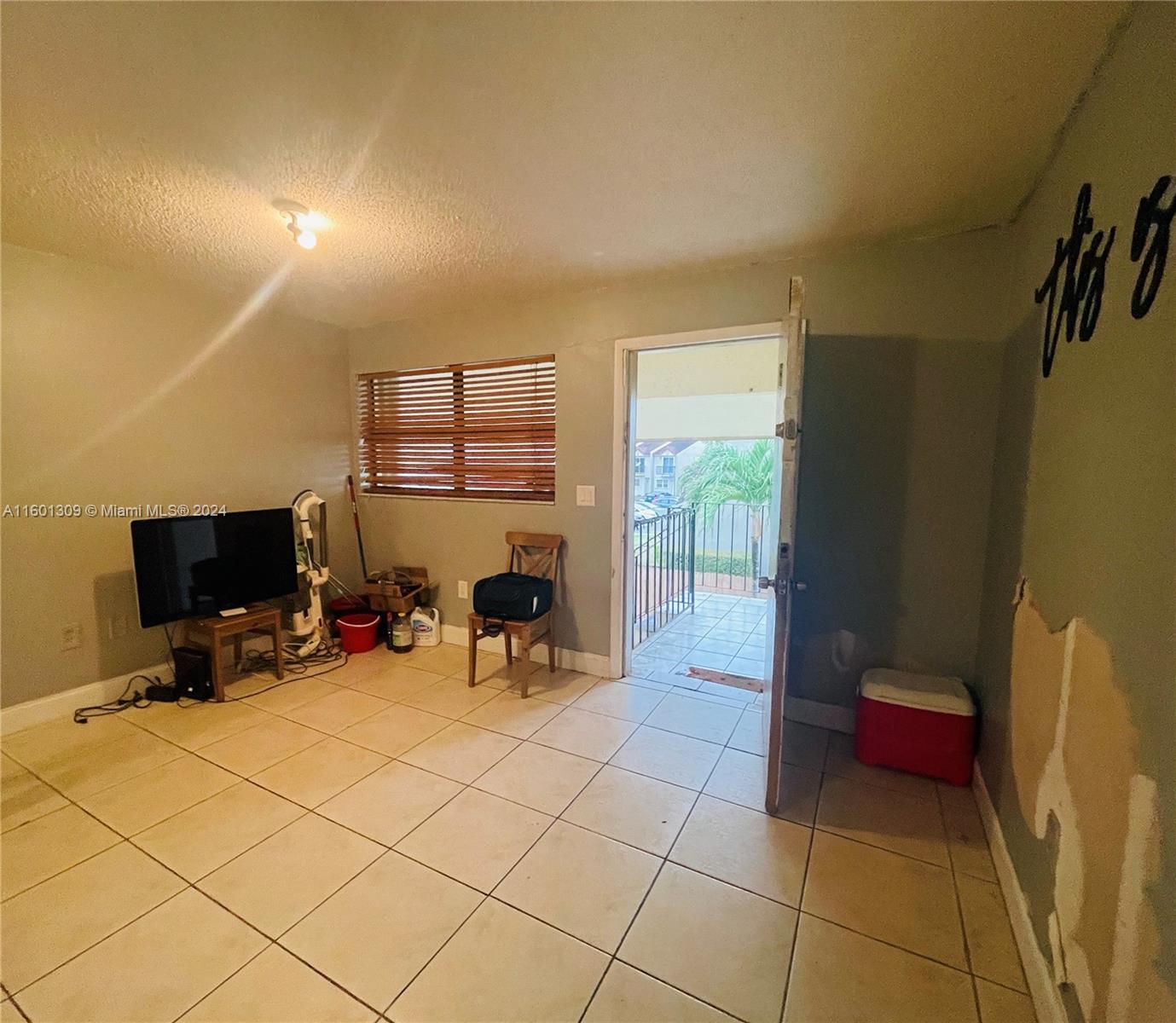 6475 Southwest 129th Place, Unit 4034 Miami, FL 33183 - Photo 4 of 15 a view of a room with gym equipment and a large window
