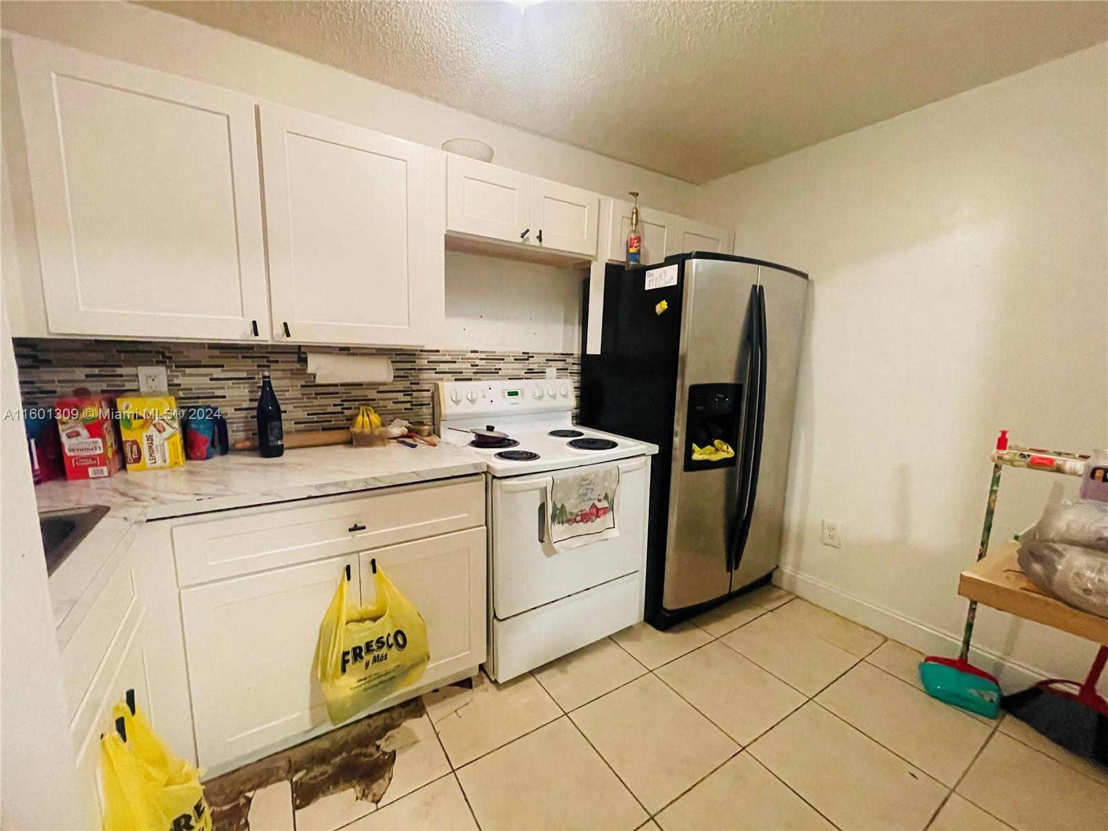 6475 Southwest 129th Place, Unit 4034 Miami, FL 33183 - Photo 5 of 15 a view of kitchen and utility room with washer and dryer
