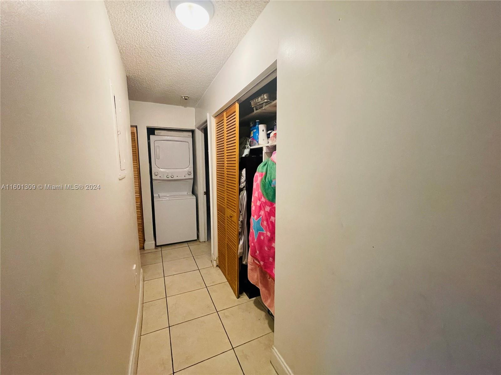 6475 Southwest 129th Place, Unit 4034 Miami, FL 33183 - Photo 7 of 15 a view of a storage & utility room with washer and dryer