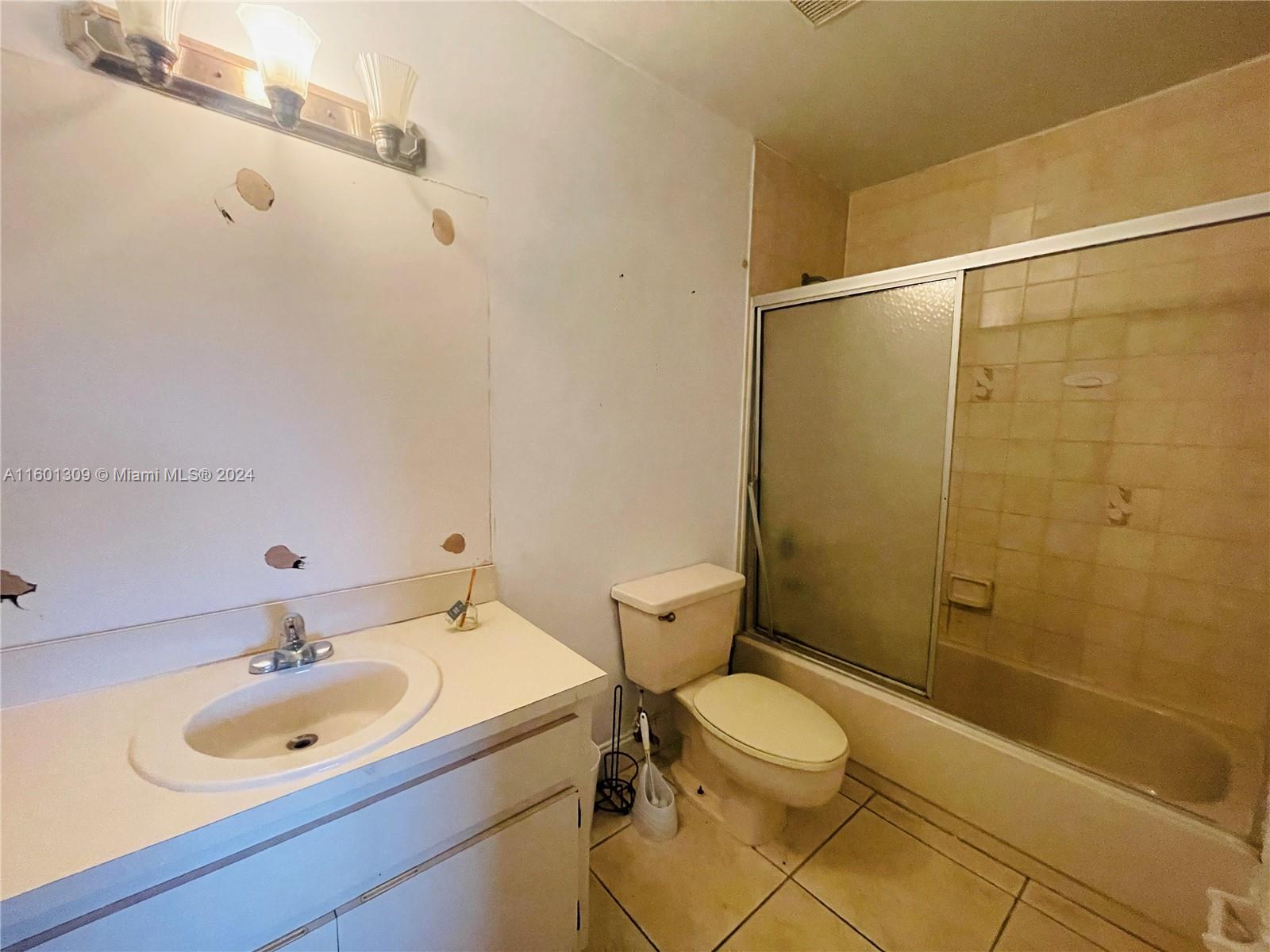 6475 Southwest 129th Place, Unit 4034 Miami, FL 33183 - Photo 9 of 15 a bathroom with a sink toilet and shower
