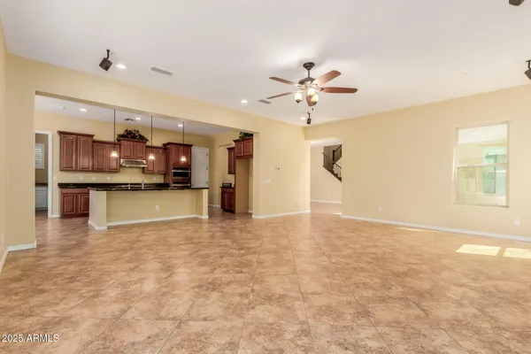 a kitchen with granite countertop a sink a counter top space and living room view
