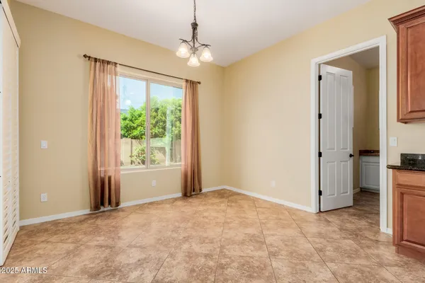 a kitchen with stainless steel appliances granite countertop a sink a refrigerator and a wooden cabinets