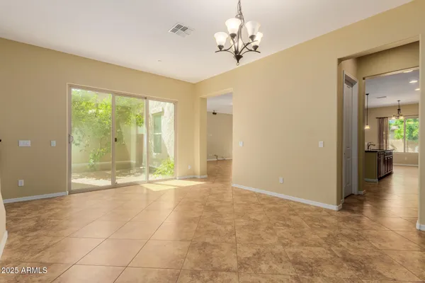 a view of a room with wooden floor and ceiling fan