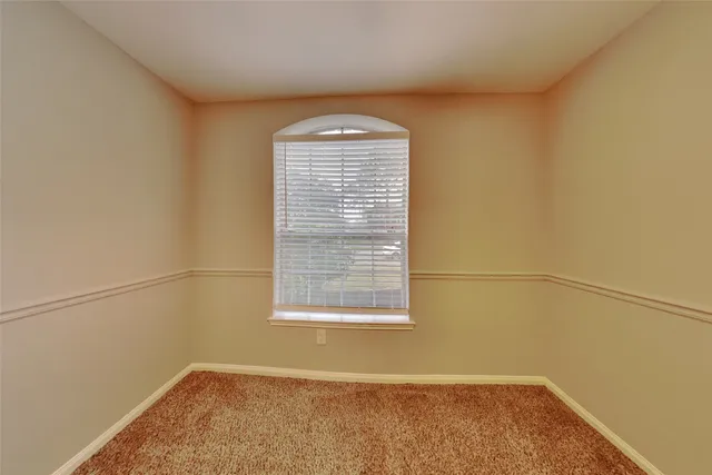 a view of a room with rack on the wall and a window