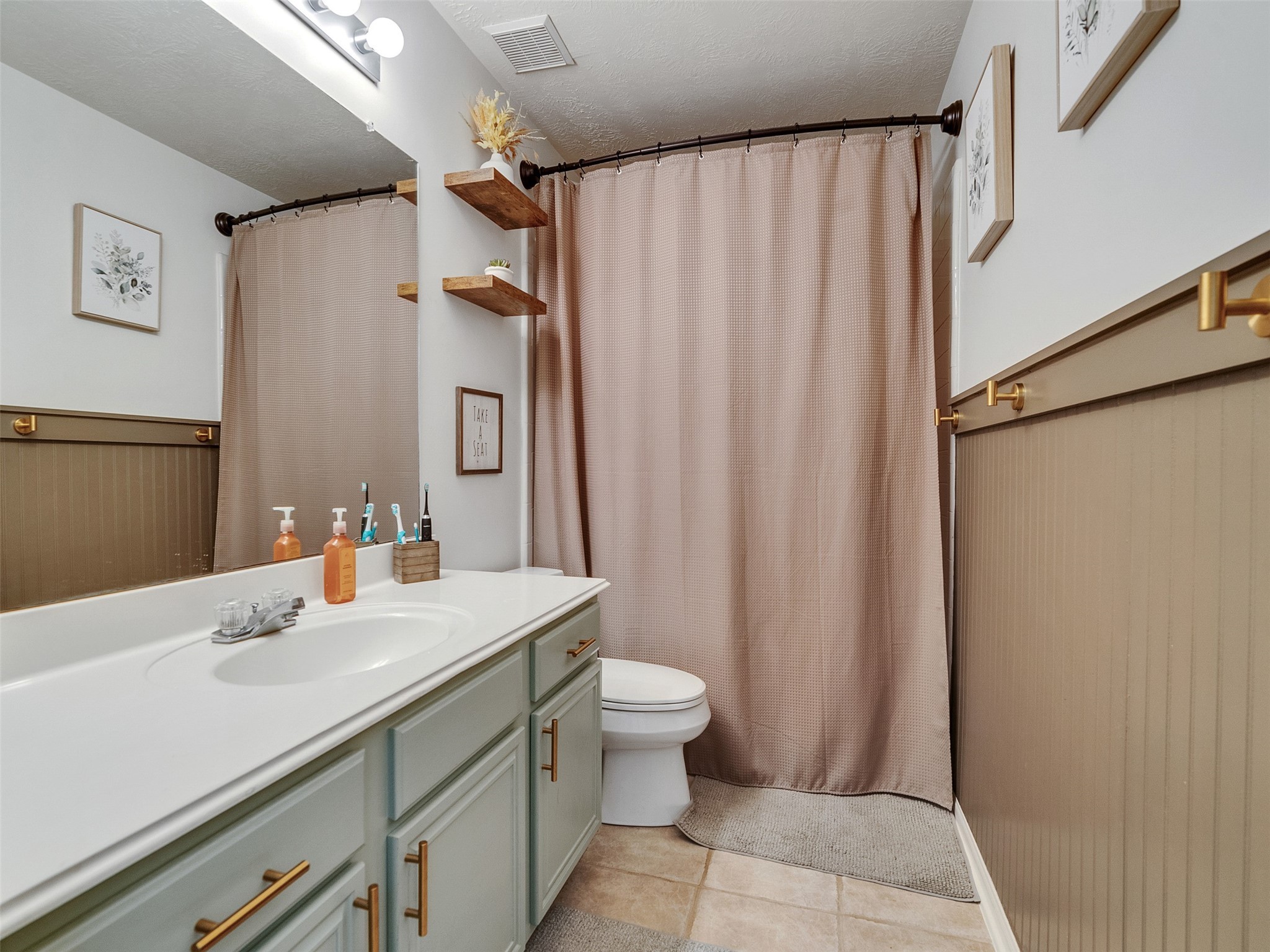 8806 Granite Gorge Drive Spring, TX 77379 - Photo 24 of 28 a bathroom with a sink a toilet and shower curtain