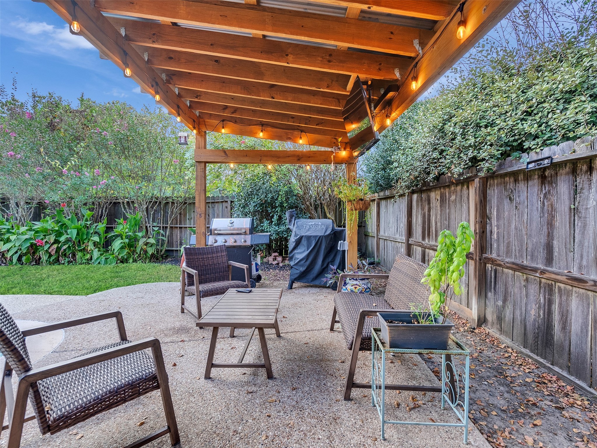 8806 Granite Gorge Drive Spring, TX 77379 - Photo 25 of 28 a view of a patio with table and chairs with wooden fence and plants