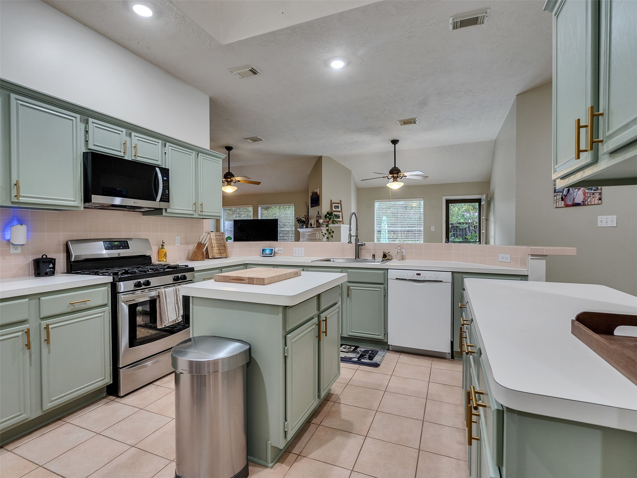 8806 Granite Gorge Drive Spring, TX 77379 - Photo 6 of 28 a kitchen with a sink stove and microwave