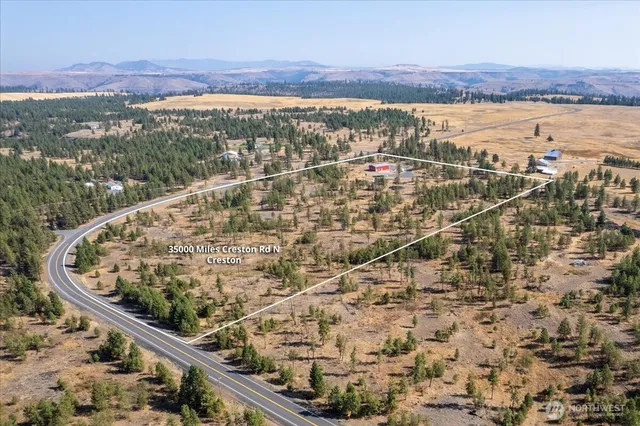 a view of a balcony with a yard
