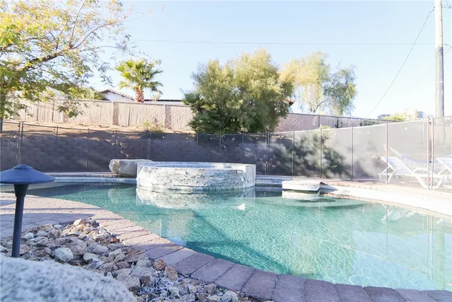 a swimming pool with wooden fence
