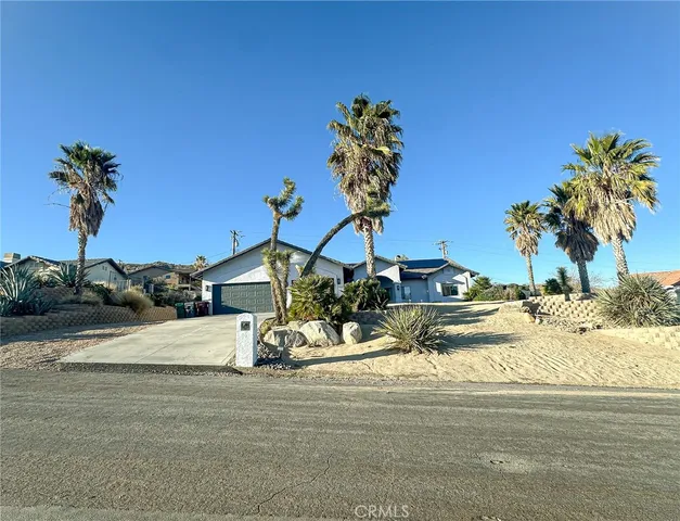 a view of a house with a yard and sitting area