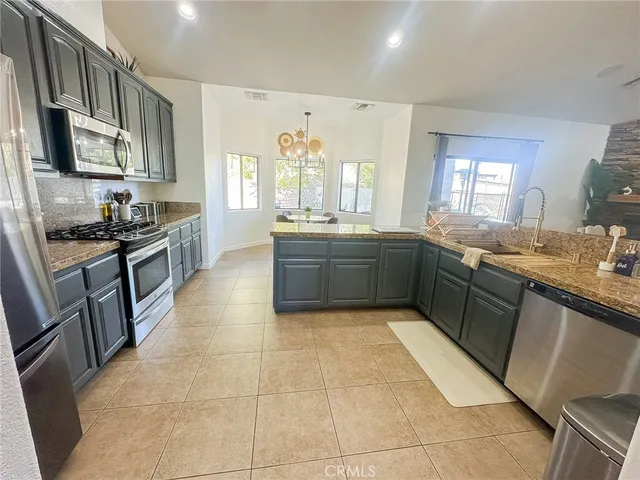 a large kitchen with a stove top oven sink and cabinets