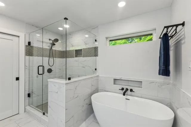 a bathroom with a bathtub and a shower