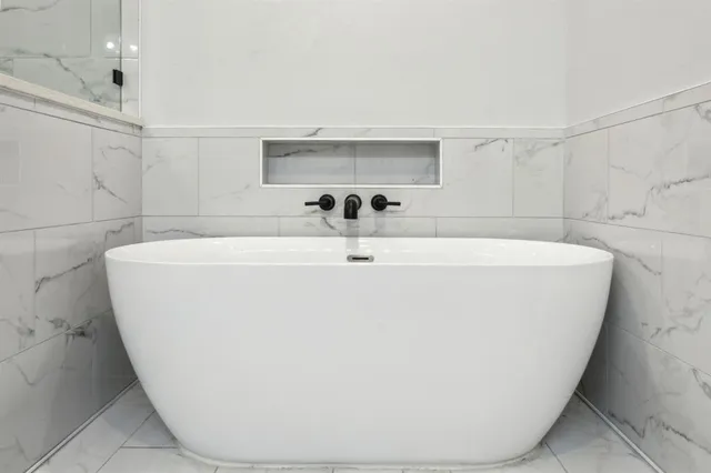 a white bath tub sitting in a bathroom