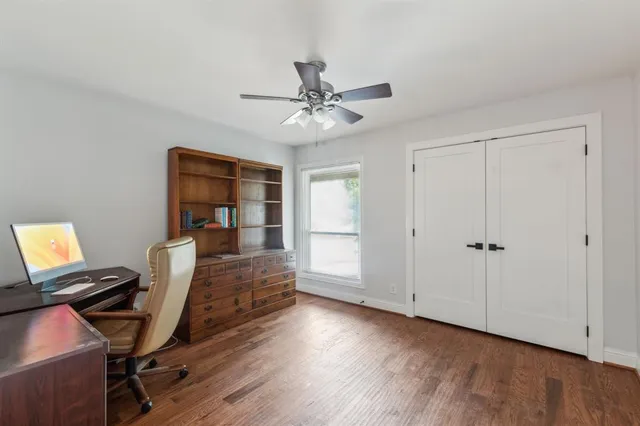 a view of a workspace with furniture and a window