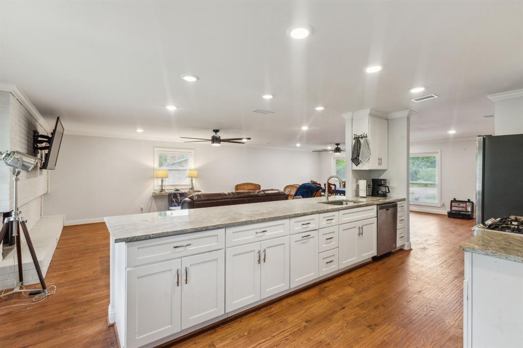 12345 Band Dallas, TX 75244 - Photo 22 of 38 a large kitchen with stainless steel appliances kitchen island granite countertop a large island in the center