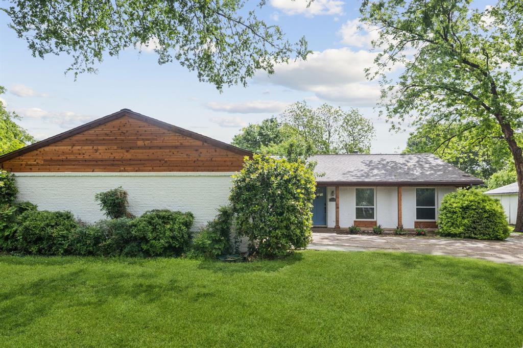 12345 Band Dallas, TX 75244 - Photo 3 of 38 a front view of a house with a garden
