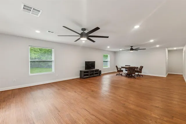 an empty room with furniture and a large window