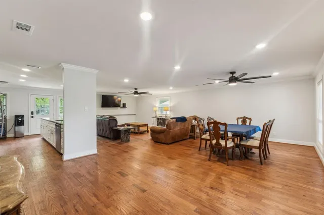a view of a dining room with furniture and a wooden floor