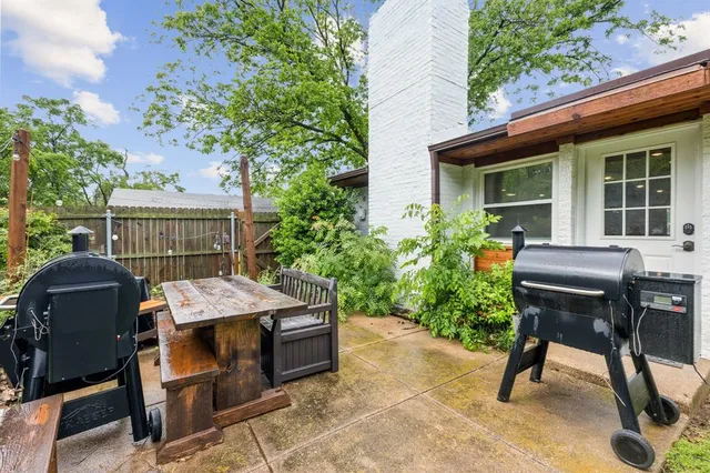 a view of a patio with table and chairs and potted plants