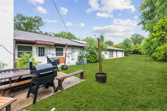 a backyard of a house with table and chairs