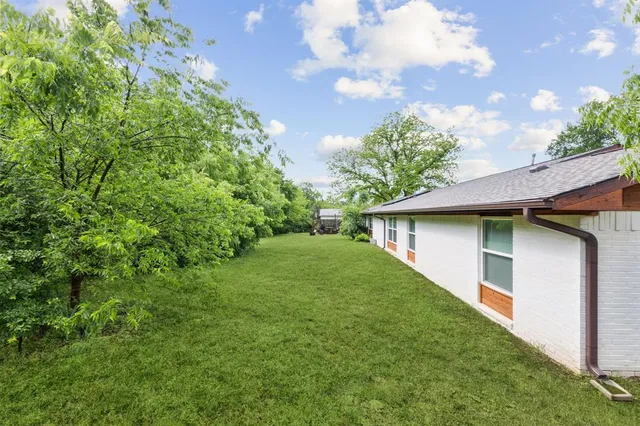 a backyard of a house with lots of green space