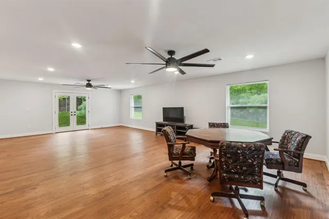 a workspace with wooden floor and a window