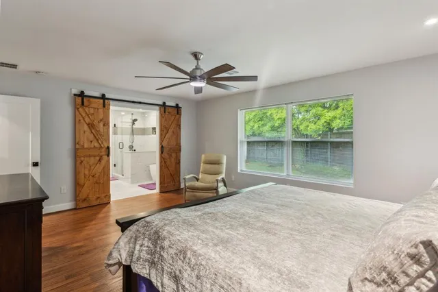 a bedroom with a bed and a large window