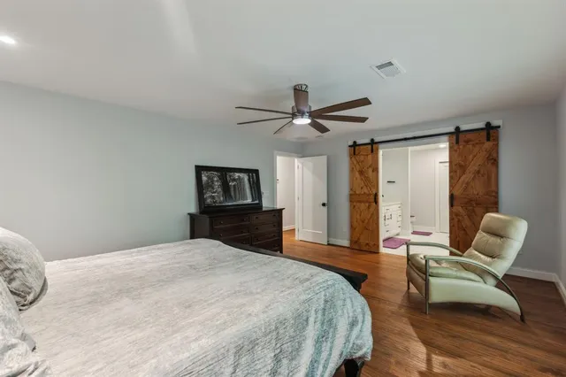 a bedroom with a bed window and couch