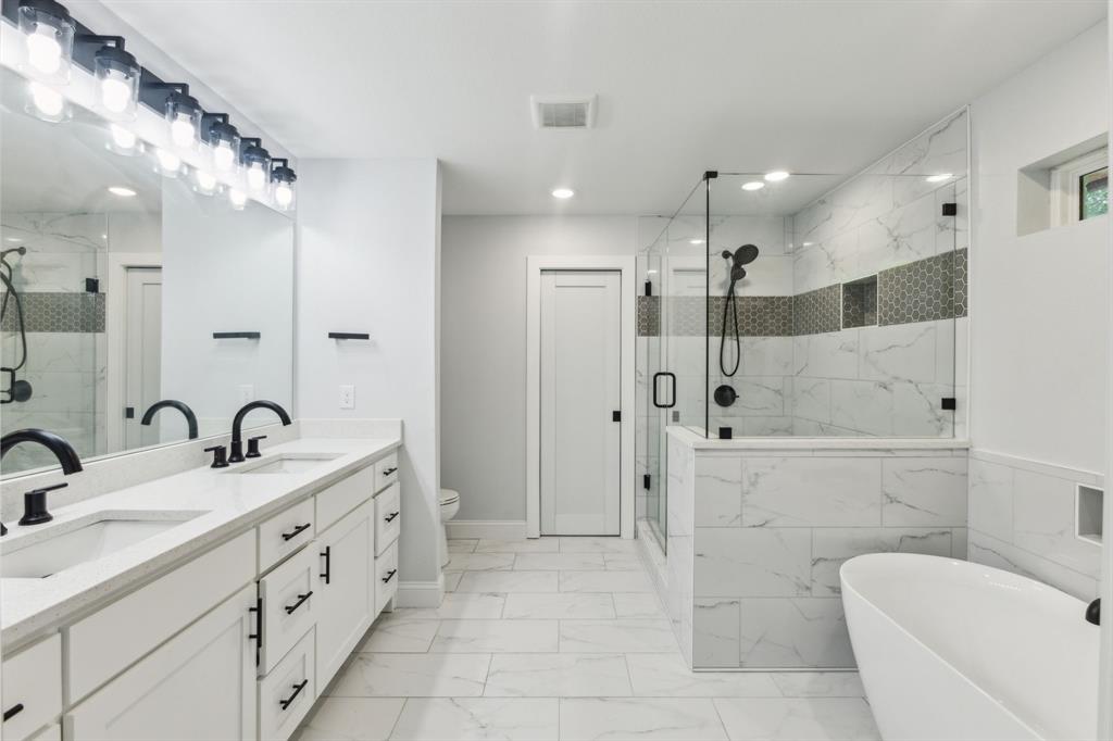 12345 Band Dallas, TX 75244 - Photo 9 of 38 a bathroom with a double vanity sink mirror and shower