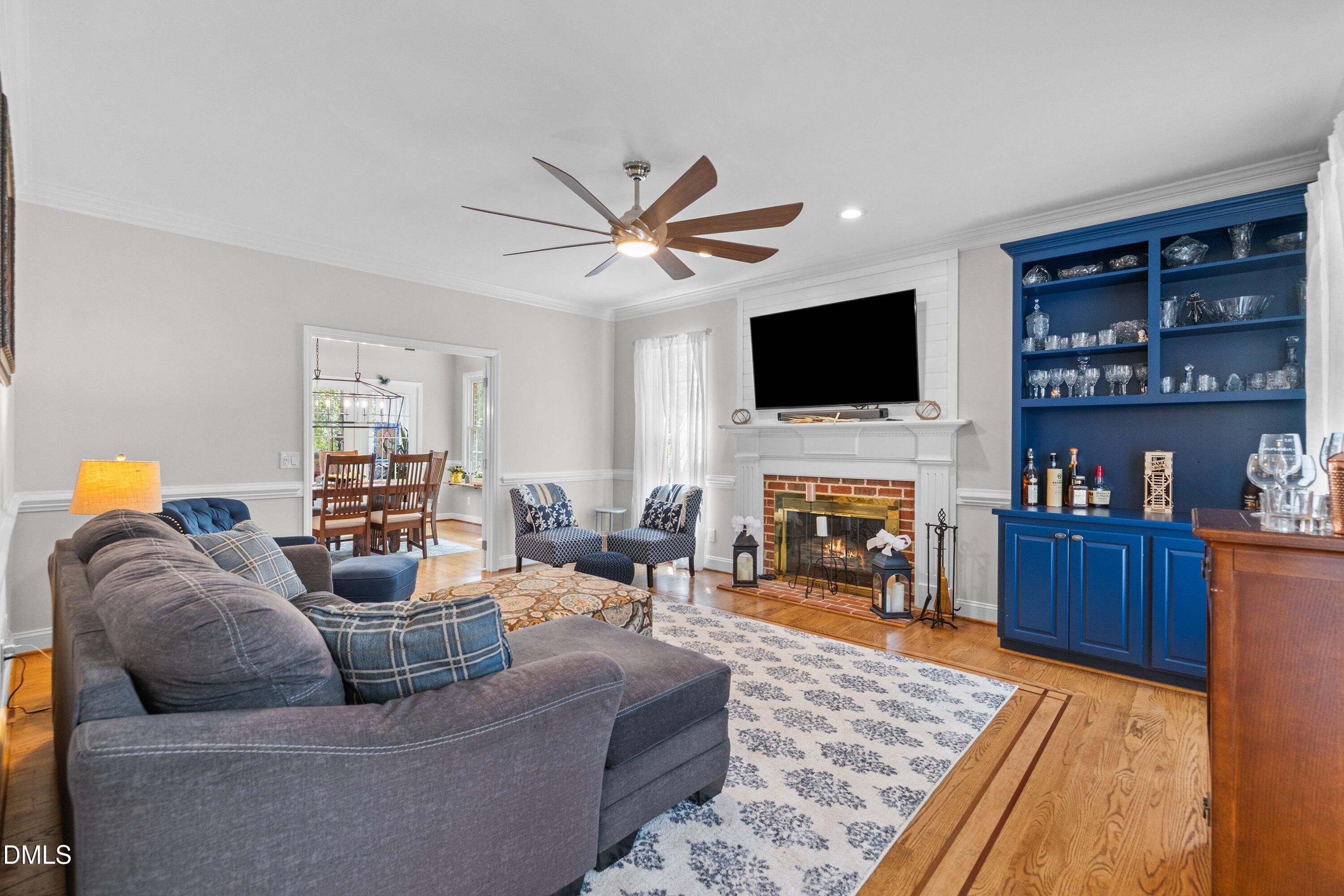 6612 Fowler Road Zebulon, NC 27597 - Photo 20 of 42 a living room with furniture a fireplace and a flat screen tv